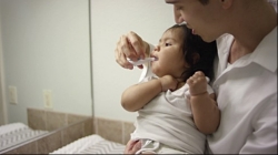 father son brushing teeth